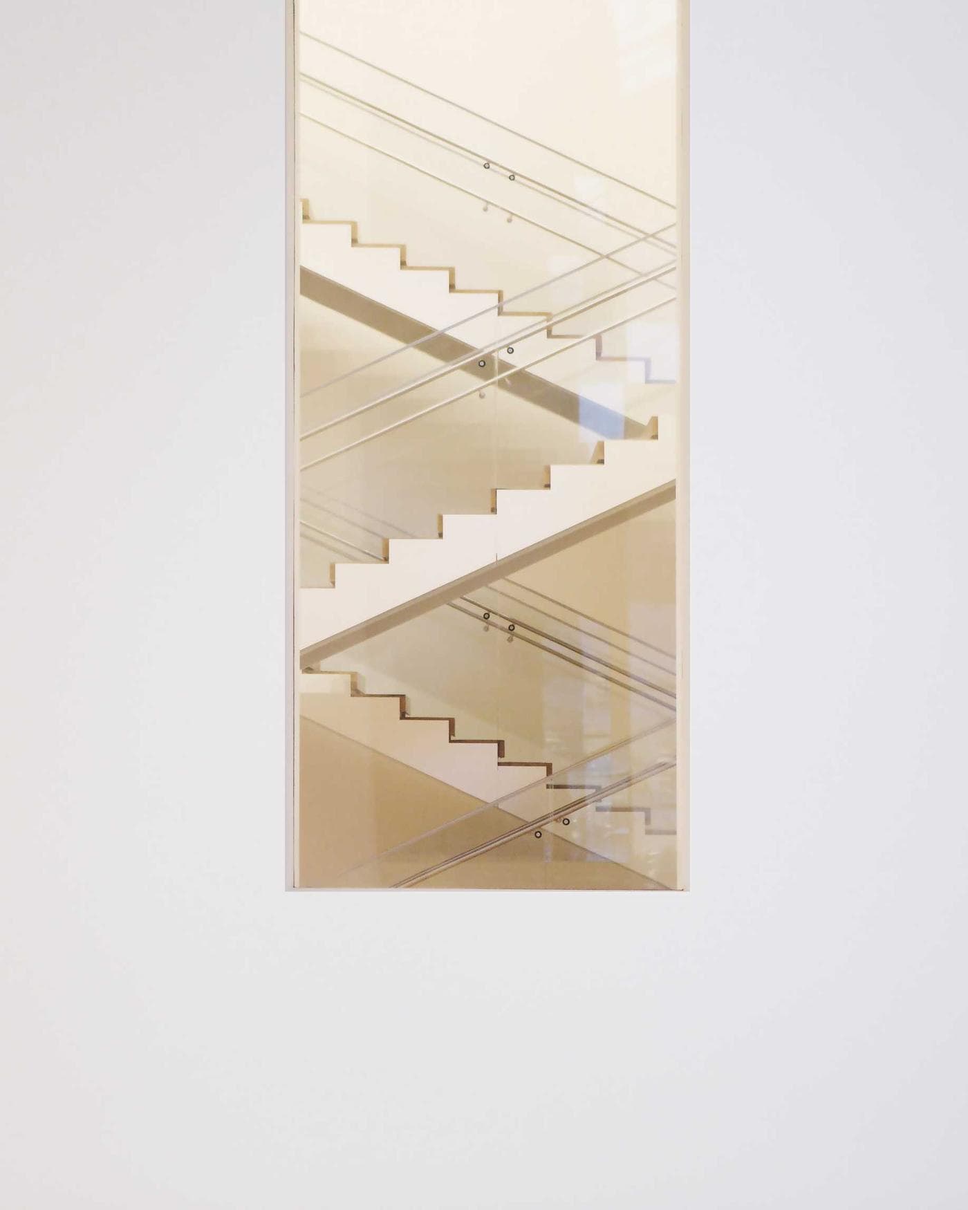 Soft daylight on a white stairway, seen through a doorway